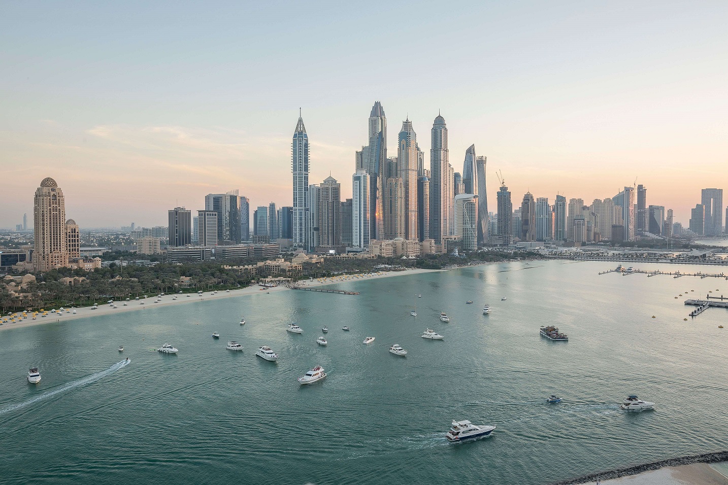 Photo credit: Dubai Marina skyline at dusk with boats on the water — Abid Ali, Pexels.com