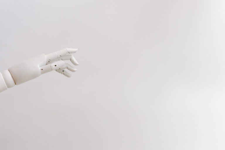 Minimalist image of a robotic hand reaching out on a white background.
