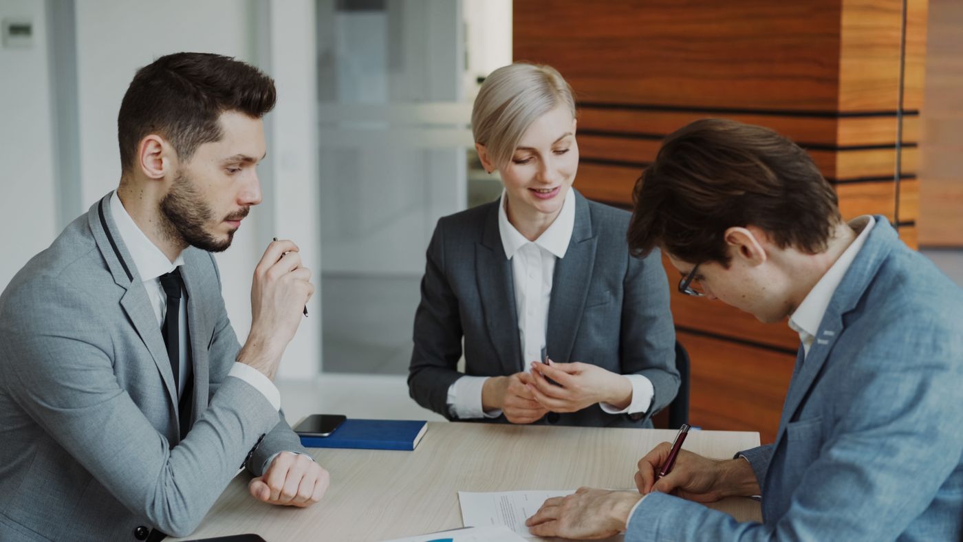 Business professionals reviewing documents at an office meeting